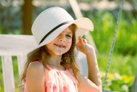Téléchargez les photos : Adorable little girl portrait closeup outdoors in summer. Happy child relax in summer green background - en image libre de droit