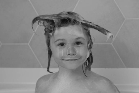 Photo for Funny kids face. Kids shampoo. Funny kid bathes in a bath with foam - Royalty Free Image