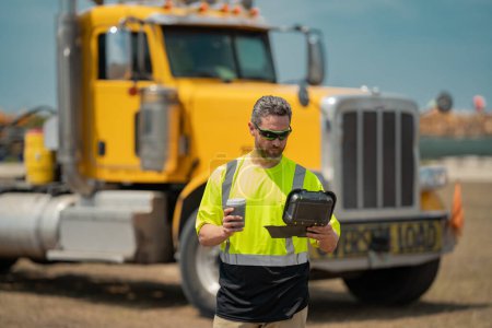 Photo for Men driver near lorry trucks. Man owner truck driver in safety vest near truck. Man driver with lunch box. Truck driver having lunch. Semi trailer, semi trucks. Handsome man posing in front of truck - Royalty Free Image