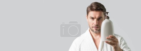 Photo for Cosmetic products. Beauty man presentation cosmetic bottle, cream. Natural cosmetics cream, spa beauty products. Man advertising cosmetic. Banner for header, copy space. Poster for web design - Royalty Free Image