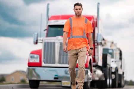 Photo for Men driver near lorry truck. Truck driver in safety vest near truck. Hispanic man trucker trucking owner. Transportation vehicles. Handsome man driver front of truck. Semi trailer semi trucks - Royalty Free Image