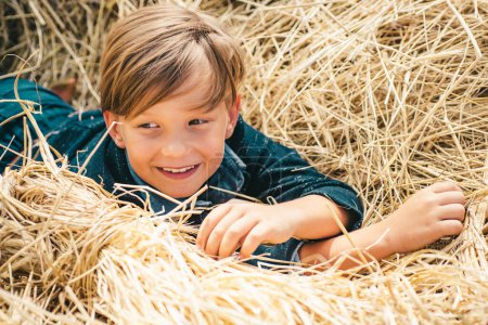Photo for Portrait of a cheerful boy lying in a hay. Autumn dream. Kid dreams on autumn nature. Childhood dream concept. Daydreamer child. Dreams and imagination. Dreamy kids face - Royalty Free Image