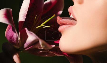 Sexy woman lick flower. Woman lips with day lily, Oriental Hybrids, lilium. Oral lesbian sex concept