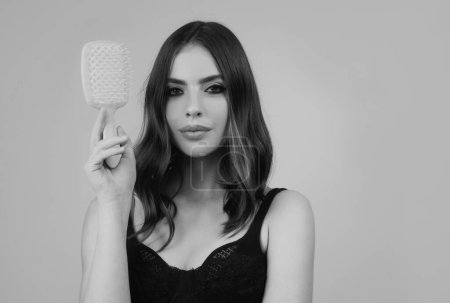 Photo for Woman brushing straight natural hair with comb. Girl combing beautiful long healthy hair with hairbrush. Hair care beauty concept. Brushing Hair - Royalty Free Image