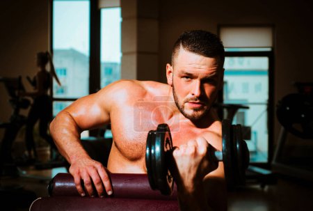 Photo for Man training with dumbbells. Dumbbell. Muscular guy exercises with dumbbells. Strong bodybuilder. Muscles with dumbbell - Royalty Free Image