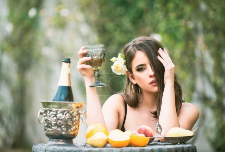 Photo for Sexy sensual woman relaxing and drink champagne. Exotic summer diet, tropical fruits - Royalty Free Image