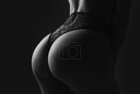 Foto de Female Buttocks slim figure, bikini thong underwear. Sexy ass in erotic lingerie. Woman sexy silhouette body in panties. Butt with sensual touch - Imagen libre de derechos