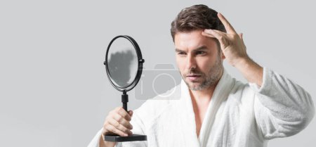 Photo for Mens beauty cosmetics, male beauty and skincare. Morning healthcare and hygiene for man. Perfect beauty skin. Handsome millennial man after shower apply facial cream or mask on skin. Wide banner - Royalty Free Image