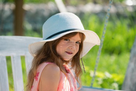 Photo for Charming cute caucasian little girl wearing straw hat standing outdoors. Funny kids face. Happy child relax in spring background - Royalty Free Image
