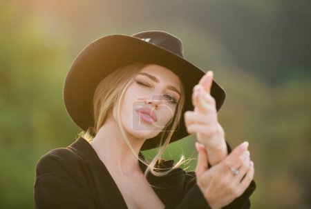 Photo for Portrait of young western woman outdoor. Romantic girl with beauty face. Female hand in gun gesture - Royalty Free Image