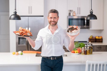 Photo for Millennial hispanic man hold salmon fillet at kitchen. Cooking salmon fillet. Restaurant menu with salmon fillet. Cooking, advertising salmon fillet concept - Royalty Free Image