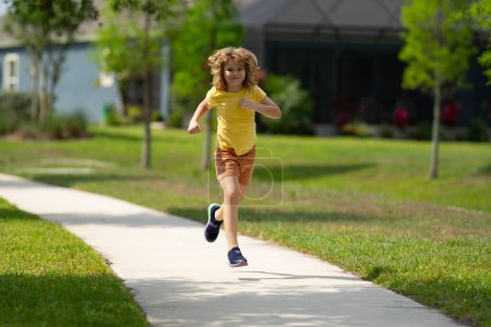 Photo for Sporty young child running jogging and training outdoor. Run and healthy sport for children. Child running on street kids fitness. Running training outdoor, morning jogging. Run exercising - Royalty Free Image