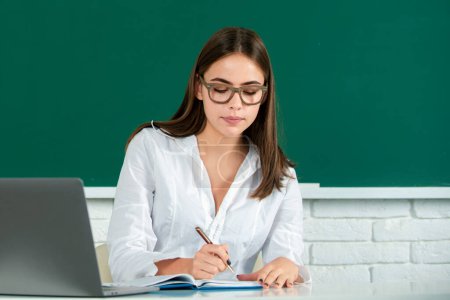 Photo for Back to school. Portrait of a young woman student with laptop in a university classroom. Female student studying. College student on blackboard. Pretty girl student on desk. Students day - Royalty Free Image