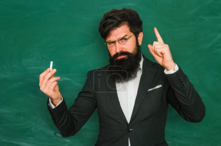 Photo for Good teacher. Serious professor teacher. Education and knowledge concept. Middle aged professor, teacher on blackboard. Bearded professor, teachers in classroom. Serious teacher. Teachers day - Royalty Free Image