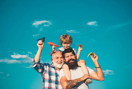 Photo for Family generation: future dream and people concept. Boy with father and grandfather. Generations men. Dream of flying - Royalty Free Image