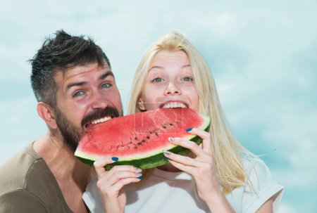 Photo for Young couple eating watermelon. Portrait of a young beautiful couple eating watermelon, Happy coupl face - Royalty Free Image