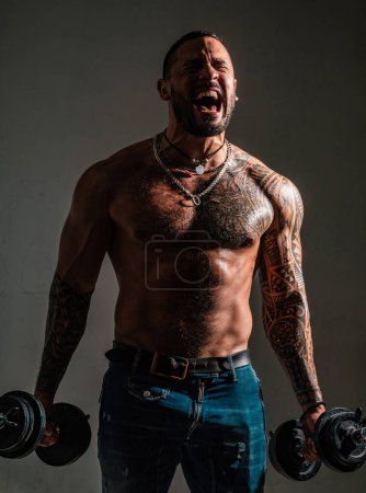 Photo for Excited strong muscular man. Sporty torso, man with dumbbells. Workout lifestyle concept. Handsome man doing functional training workout - Royalty Free Image