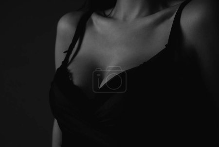 Sexy woman breast. Boobs in bra, sensual tits. Beautiful slim female body. Lingerie model. Closeup of sexy female boob in black bra