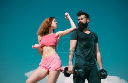 Photo for Sporty fitness couple. Healthy lifestyle concept. Beautiful attractive fitness friends. Abs fitness woman body. Female model in sportswear exercising outdoors - Royalty Free Image