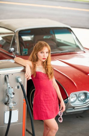 Photo for Red retro automobile. Old American Car. Gas station girl. Woman refuel the auto - Royalty Free Image