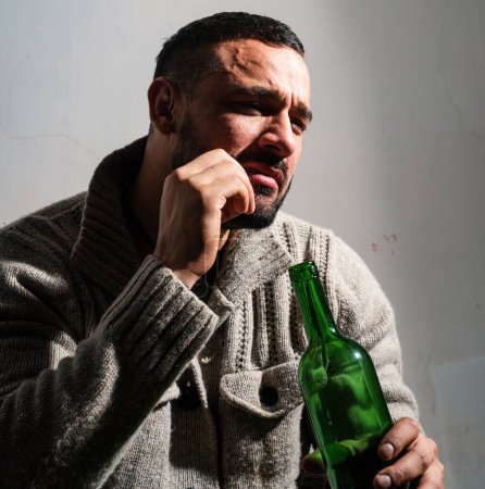 Photo for Alcohol addicted man. bachelor and single. lonely man drink wine from bottle. Sad depressed male adult has troubles with alcohol. addicted guy. concept of alcohol addicted. he is alcohol addicted. - Royalty Free Image
