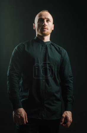 Photo for Man with serious face and brutal style. Man in a suit on a dark background. Short beard. Close up portrait of severe hot guy. Confident concept. Serious stylish bearded man - Royalty Free Image