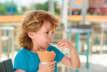 Photo for Cute child eating ice cream outdoors. Sweet summer day - Royalty Free Image