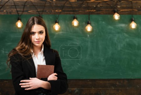 Photo for Dating. Young student in class. School lessons. First grade. First love in school. Young cute teenage girl in classroom at blackboard. Blackboard copy space - Royalty Free Image