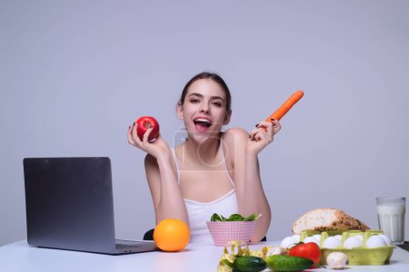Photo for Vegetables diet. Happy smiling woman eating healthy food, dieting. Girl eating vegetable diet salad in studio. Vegan salad. Female on diet. Dieting concept. Healthy lifestyle. Diet for weight loss - Royalty Free Image