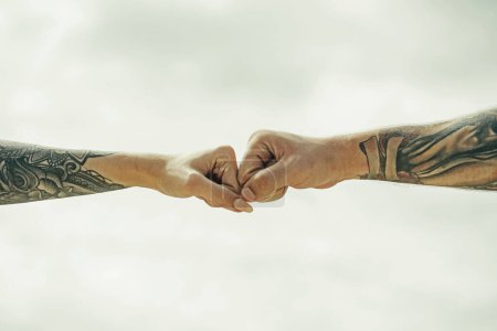 Photo for Couple hands with tattoo. Helping hand. Holding hand, close up. Giving a help hand. Rescue, helping gesture or hands. Salvation relations. Help gesture or hands. Support hand - Royalty Free Image