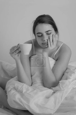 Photo for Woman with morning coffee on the bed - Royalty Free Image
