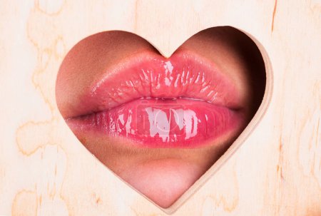 Photo for Heart shape. Girl Natural beauty lips. Red lip with glossy lipgloss. Close up, macro with beautiful mouths. Sexy kiss, sensual seductive lips of a young woman. Cosmetics and beauty salon - Royalty Free Image