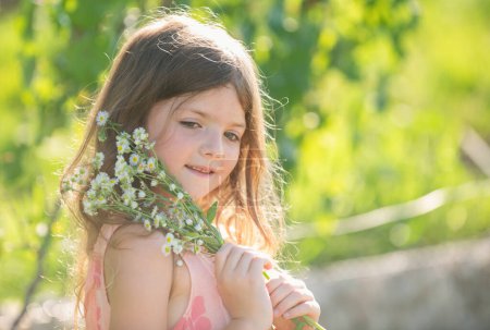 Photo for Cute little child girl picking flowers in blooming summer garden. Spring child face. Happy little child with flowers on the grass in a summer. Cute little child on the meadow in backyard - Royalty Free Image