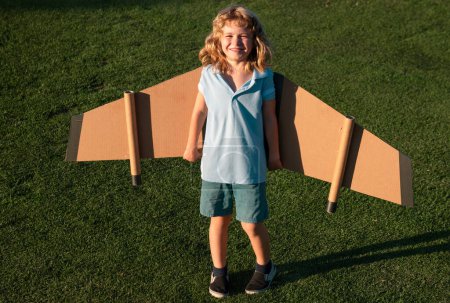 Photo for Cute dreamer boy playing with a cardboard airplane. Childhood. Fantasy, imagination - Royalty Free Image