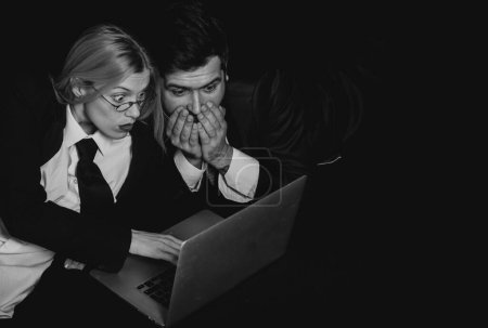 Photo for Business people. Business colleagues couple isolated over black background using laptop computer - Royalty Free Image