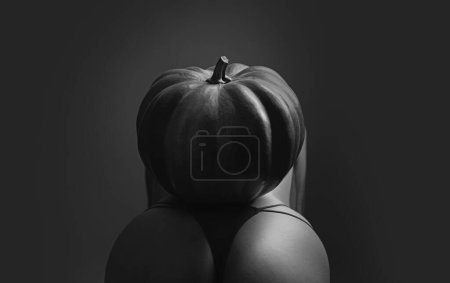 Foto de Halloween party. Sexy woman with big ass. Halloween witch with a carved pumpkin and magic lights. Wide Halloween party art design. Night club and sexy costume concept. Halloween festival decorations - Imagen libre de derechos