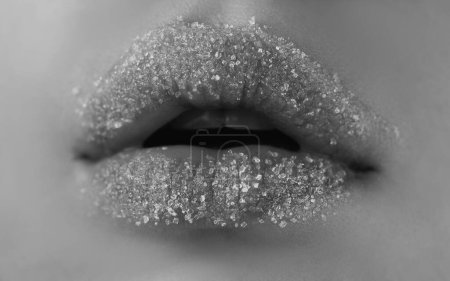 Téléchargez les photos : Des lèvres en sucre. Lèvres serrées avec sucre. Soins de beauté. Cosmétiques Lipscare - en image libre de droit