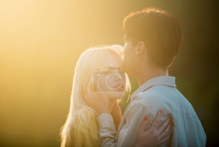 Photo for Couple lovers hugging and kissing at sunset. Portrait of lovely couple in love. Young sensual girlfriend glad to passionate kiss from her boyfriend. Handsome young man embraces his woman and kisses - Royalty Free Image