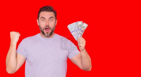 Photo for Portrait business man holding cash dollar bills over red studio background. Big luck, banner. Dollar cash money concept. Rejoices to win cash. Man hold cash money. Financial luck and success - Royalty Free Image