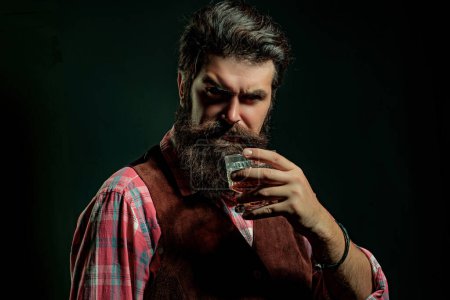 Photo for Alcohol Drink. Hipster with beard and mustache in suit drinks alcohol after working day - Royalty Free Image