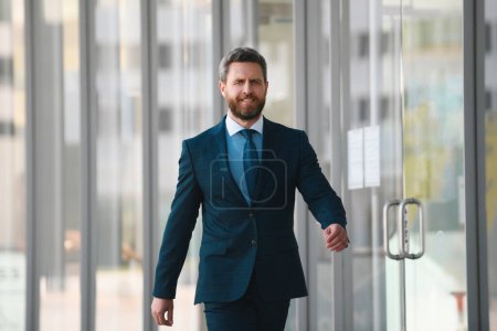 Photo for Businessman walking in city. Confident and successful. Handsome business man while walking outdoors near office building - Royalty Free Image