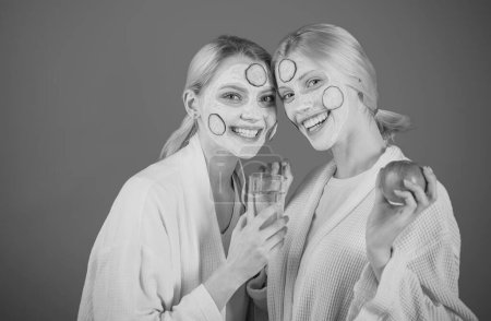 Photo for Beautiful nature smiling blonde women friends stand face to face and make healthy spa skincare. Happy friendship and health concept - Royalty Free Image