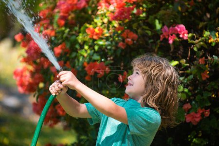 Photo for Child is watering the plant outside the house, concept of plant growing learning activity for kids and children education for the nature - Royalty Free Image