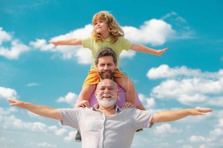 Photo for Portrait of parent grandfather, son and grandson raising hands or open arms flying. Parenting parenthood concept - Royalty Free Image