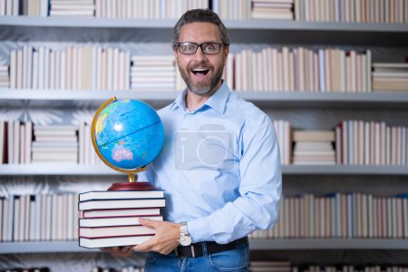 Photo for Teachers day. Teacher tutor in school classroom. Knowledge, education. Man with book teaching lesson in class. University exam. Study teach in college. Educator learning courses. Studying geography - Royalty Free Image