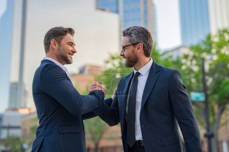 Photo for The two business team worked together to achieve their goals. Business man shaking hands. Two businessmen handshake outdoor. Handshake business people - Royalty Free Image