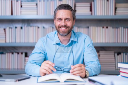 Photo for Teacher in classroom. Knowledge and education with handsome teacher. Teacher with book in classroom. Man on lesson in class. Teachers from university exam. College teacher. Teaching and learning - Royalty Free Image