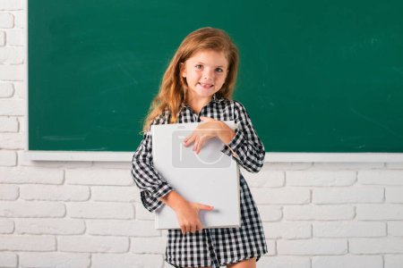 Photo for Cute little child studying in classroom at elementary school. Kids education and knowledge. Student kids - Royalty Free Image