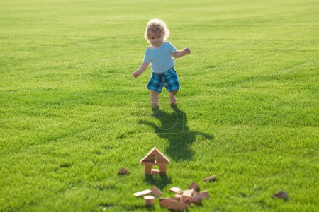 Photo for Insurance kids. Child development. Baby play in green grass - Royalty Free Image