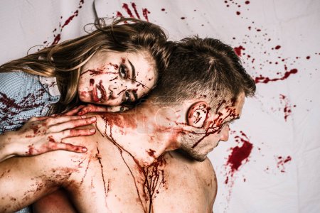 Téléchargez les photos : Couple in blood. Terrifying zombie couple. Fresh tasty beef. Zombie - en image libre de droit